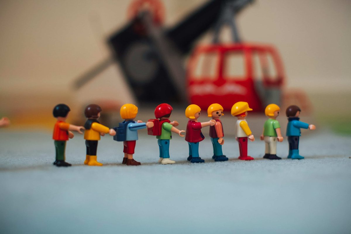 A line of small toy figures standing shoulder to shoulder