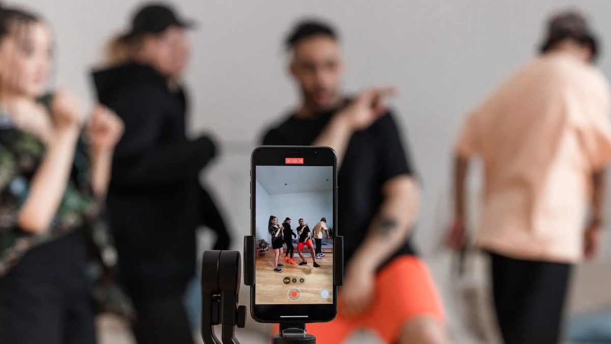 A phone on a tripod filming a group of dancers