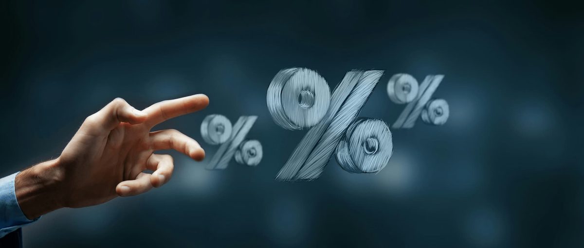 A hand reaching towards floating percentage symbols