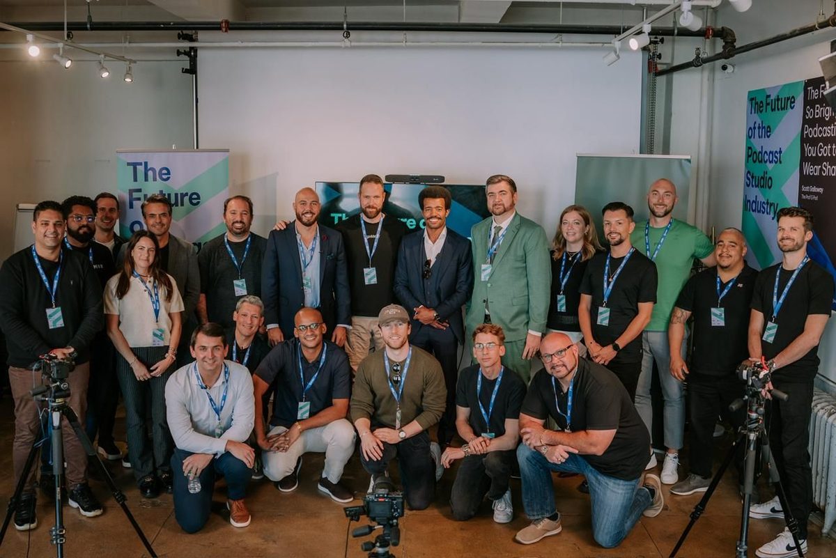 A large group of podcast studio owners posed together at a meetup