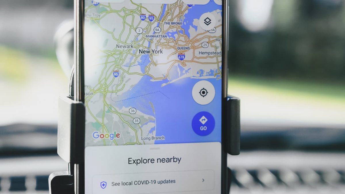 A phone mounted on a stand showing a map of nearby places