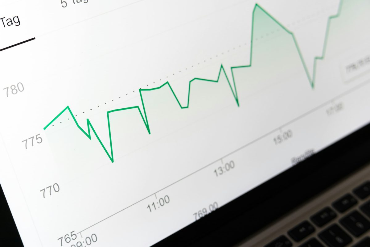 A line chart trending upwards on a laptop screen