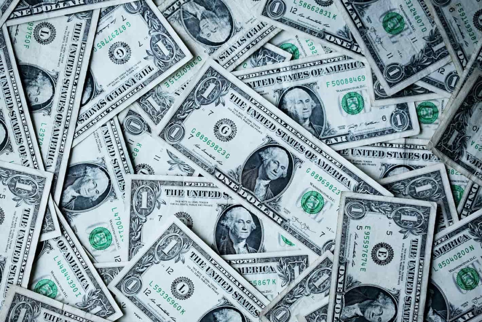A pile of overlapping one dollar bills