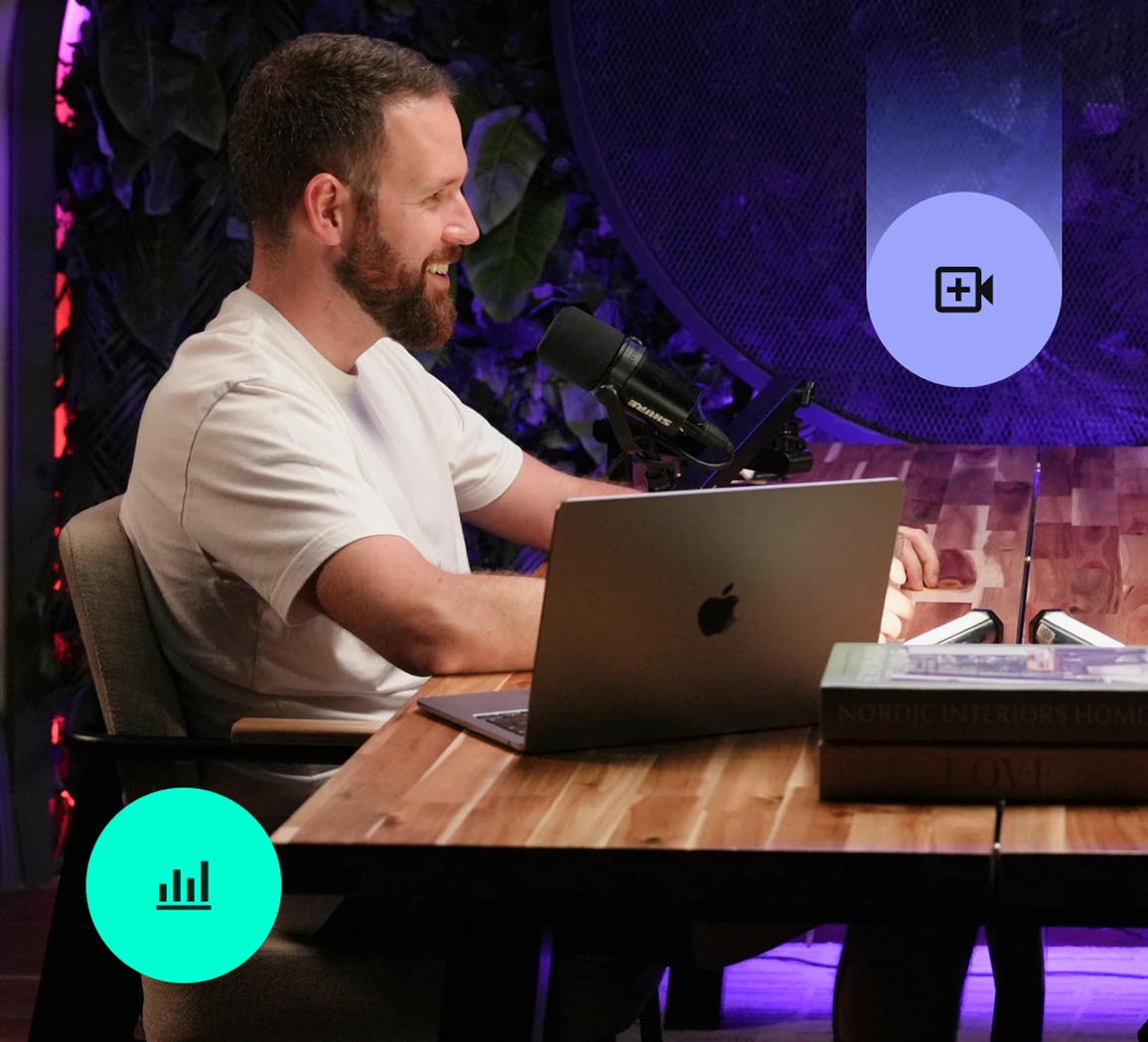 A studio owner working at a laptop in a purple-lit podcast studio, with a video badge on the frame