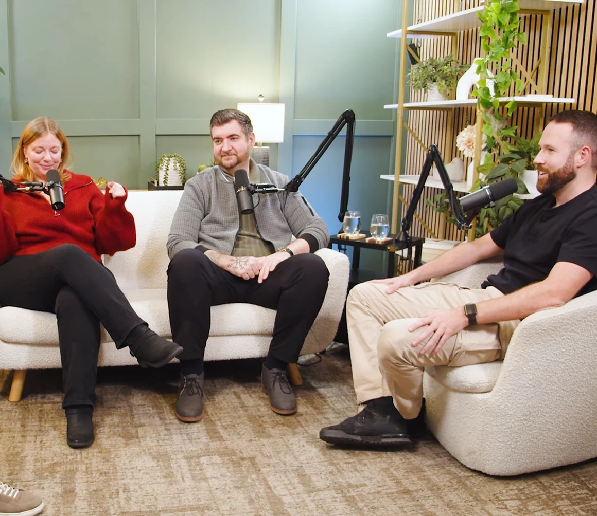 Four people recording together on sofas in a bright podcast studio