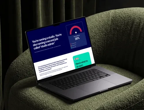 A laptop on a green armchair showing a Podyx studio quiz result with a 38% score